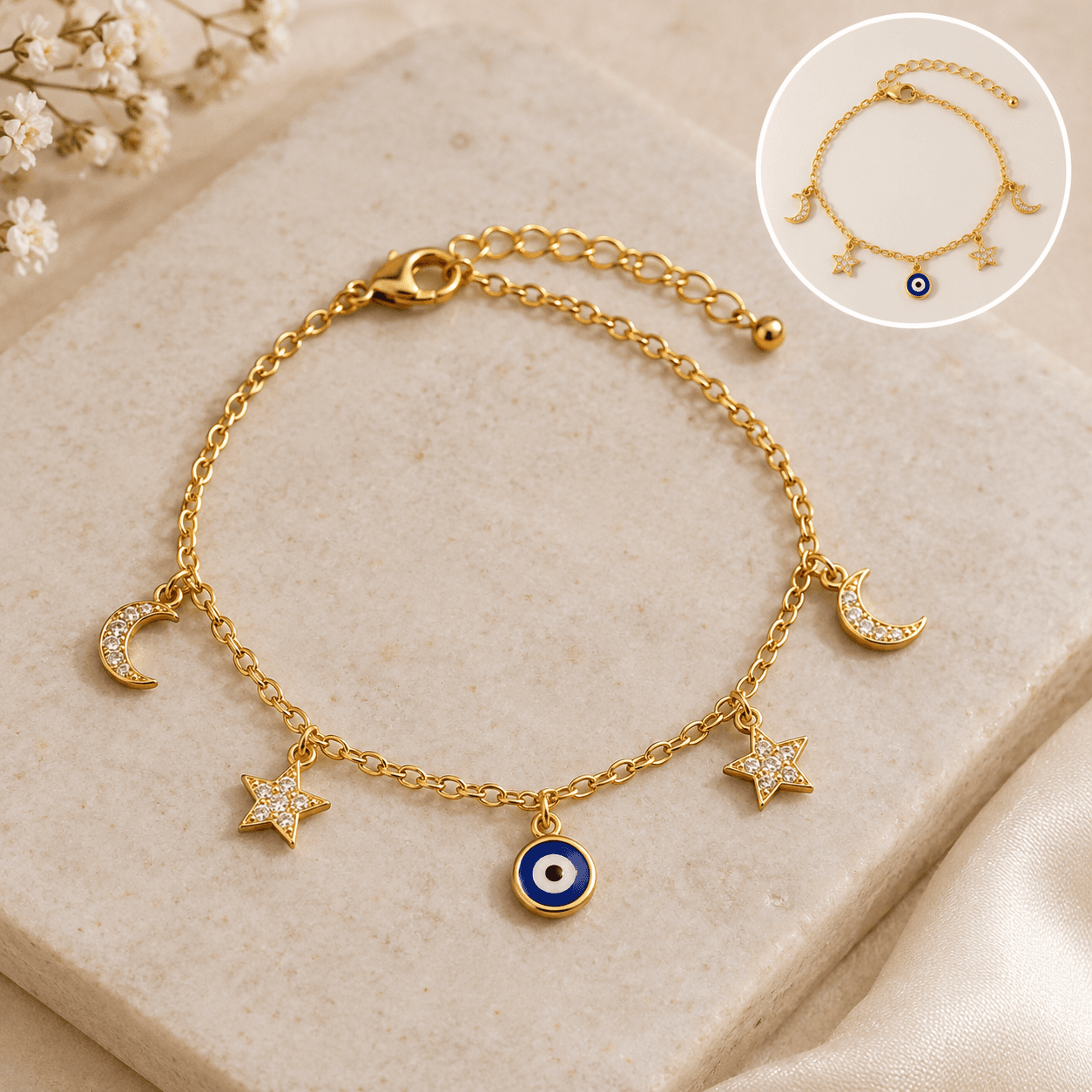 Gold charm bracelet with moon, star and evil-eye charms
